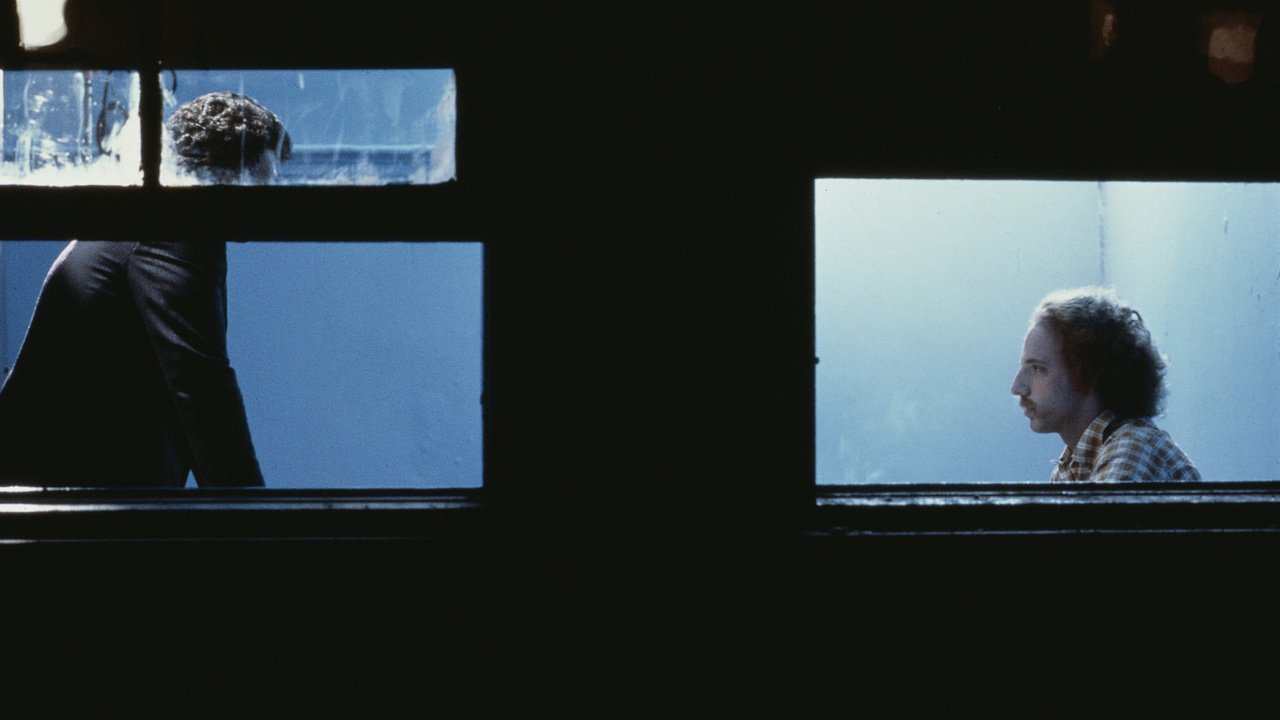 window view of a man being interrogated